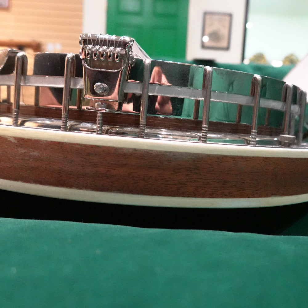 close up of banjo resonator with damage to the resonator