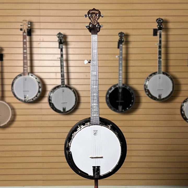 Artisan Special banjo full front photo with Banjos displayed on a wooden wall