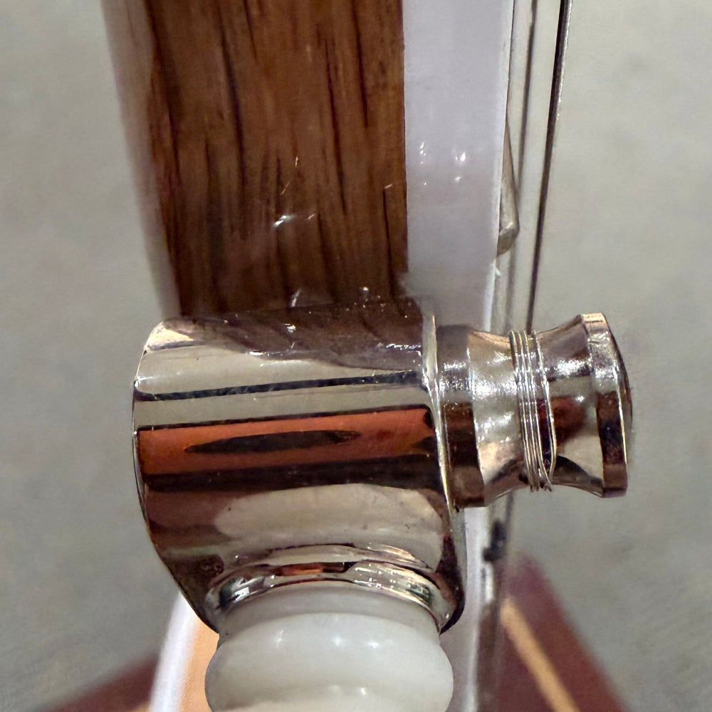 close up of 5th string peg biding damage