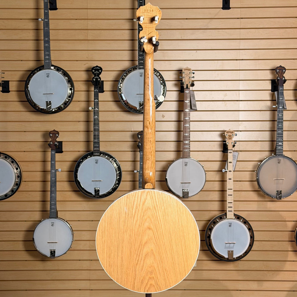 Collection of banjos displayed on a wooden wall panel