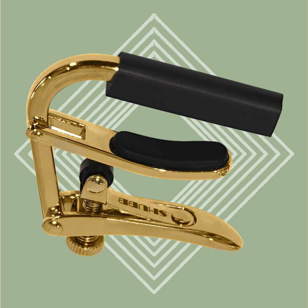 Shubb Banjo Capo - Gold, green background