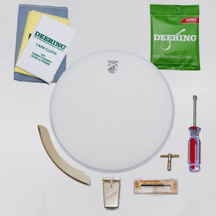 Deering Banjo Care Package front, all three care clothes, one pack of Deering Light gauge strings, truss rod wrench, tr wrench, packaged Deering Smile bridge, Deering True Tone Tailpiece, banjo head, Deering armrest, white background